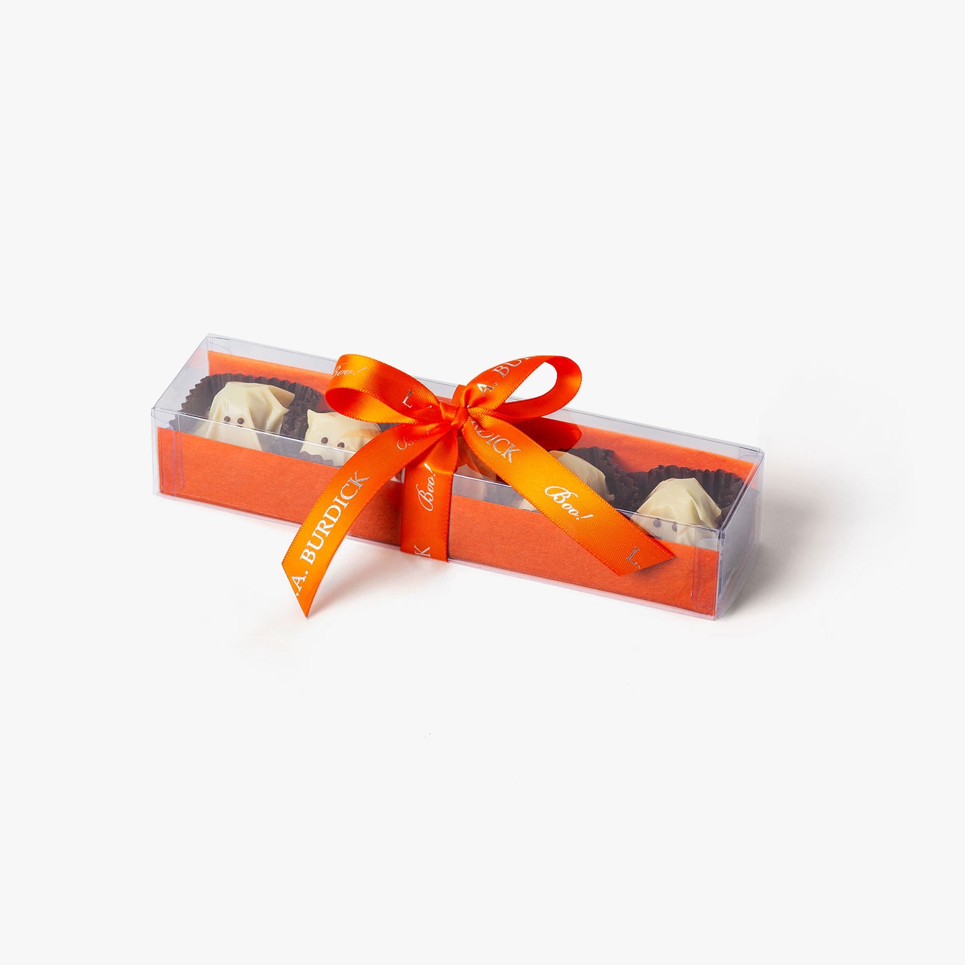 White chocolate covered ghosts nestled in packaging and tied with an orange ribbon for Halloween